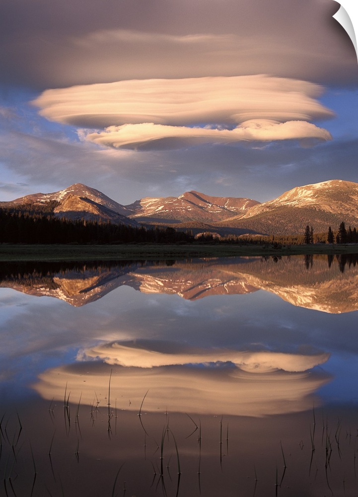 Tall canvas photo art of billowing clouds above rolling hills reflected in the water.
