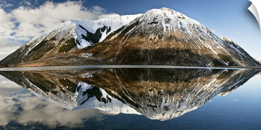 Mountains reflecting in Lake Pearson in winter, Castle Hill Basin, Canterbury, New Zealand
