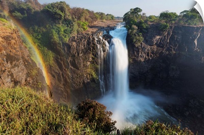 Rainbow formed in mist from waterfall, Victoria Falls, Zimbabwe