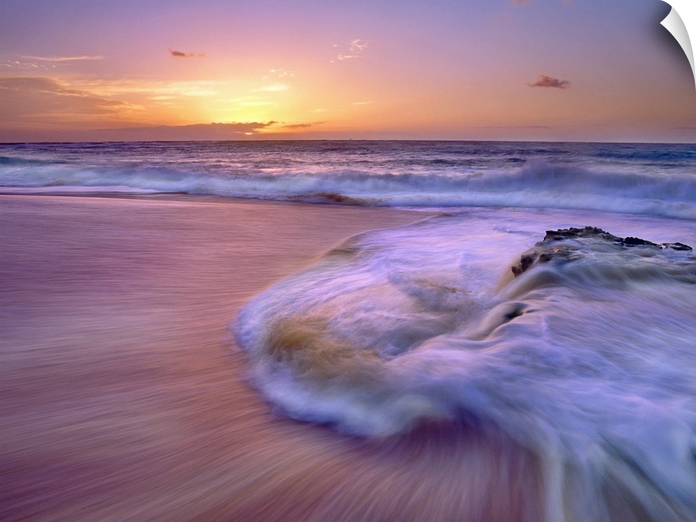 Wall docor of waves rushing ashore on a beach with an Hawaiian sunset in the distance.