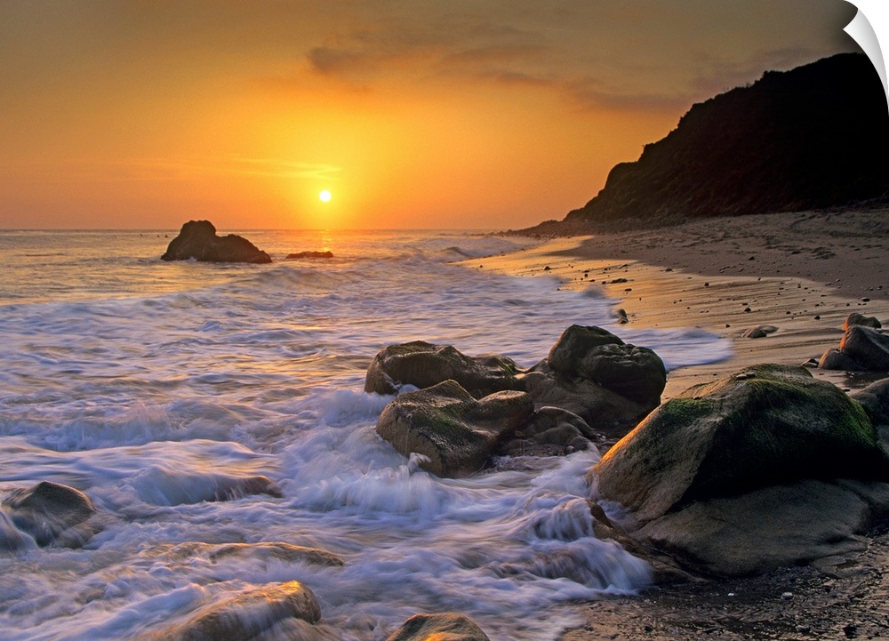 Large landscape photograph of a golden sunset over the rocky shoreline at Leo Carrillo State Beach, Malibu, California.
