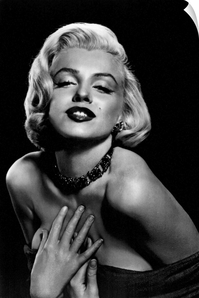 Vintage black and white photograph of the actress leaning in and holding her hands to her chest, with dark lipstick and a ...