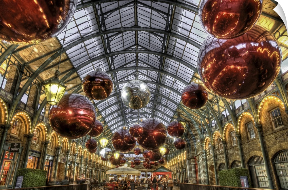 Photograph of the interior of an indoor garden with Christmas decorations hanging from the ceiling.