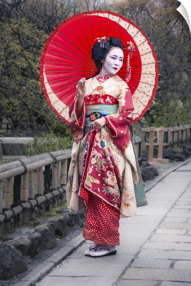 A photograph of a woman in traditional Japanese geisha attire.