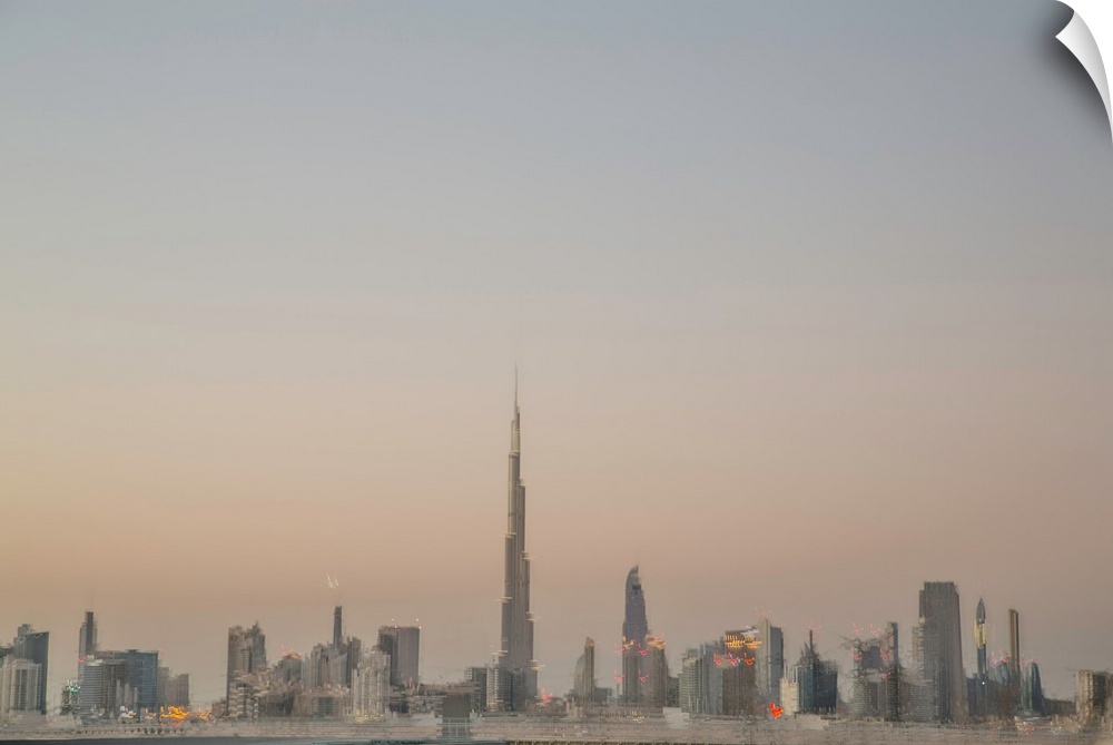Photograph of a blurred Dubai skyline created with multiple exposures, at dusk.