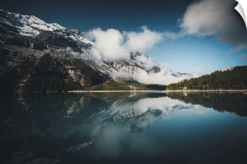 Mountain lake in Switzerland with reflection of a mountain