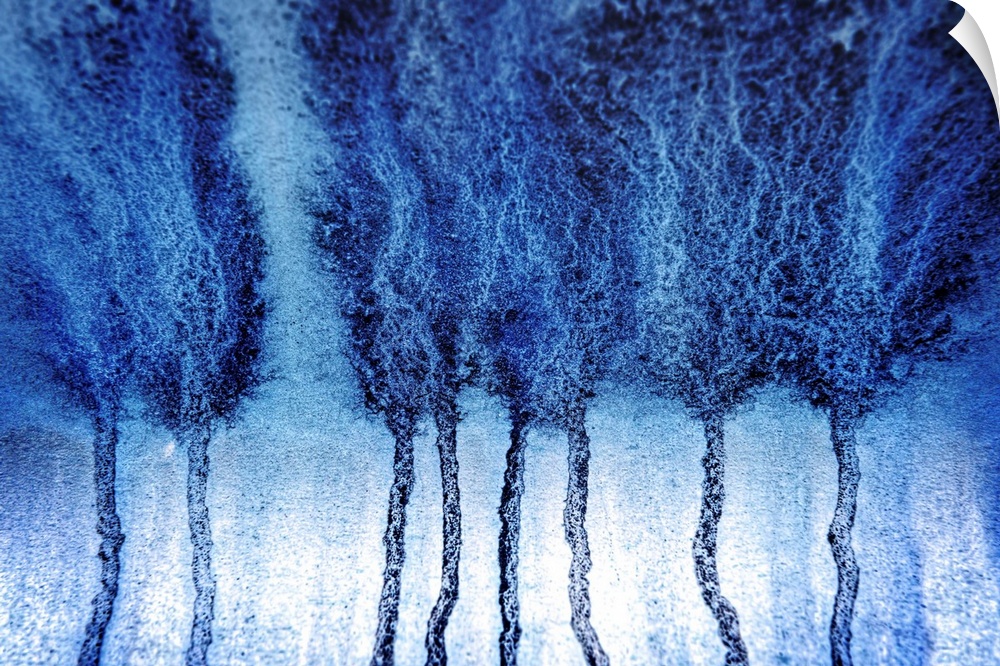 Abstract artistic photograph of blue paint dripping down a surface.