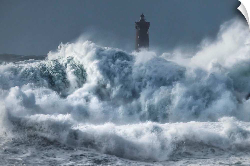 A photograph of a lighthouse in France being hit with crashing waves.