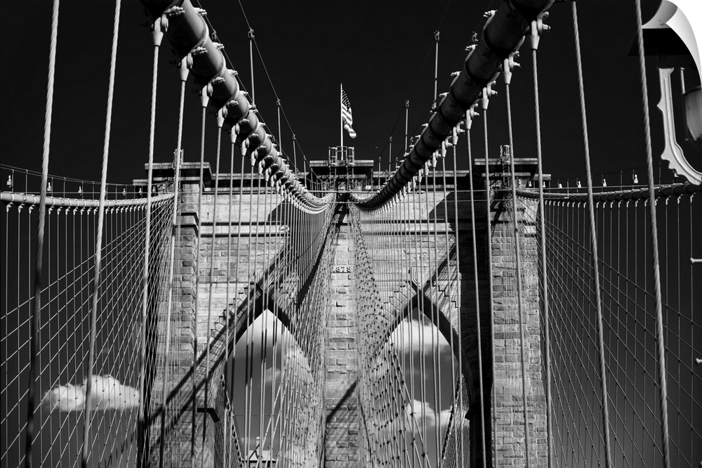 Low Angle View of a Stone Tower with Steel Cables and The US Flag, Brooklybn Bridge, New York City