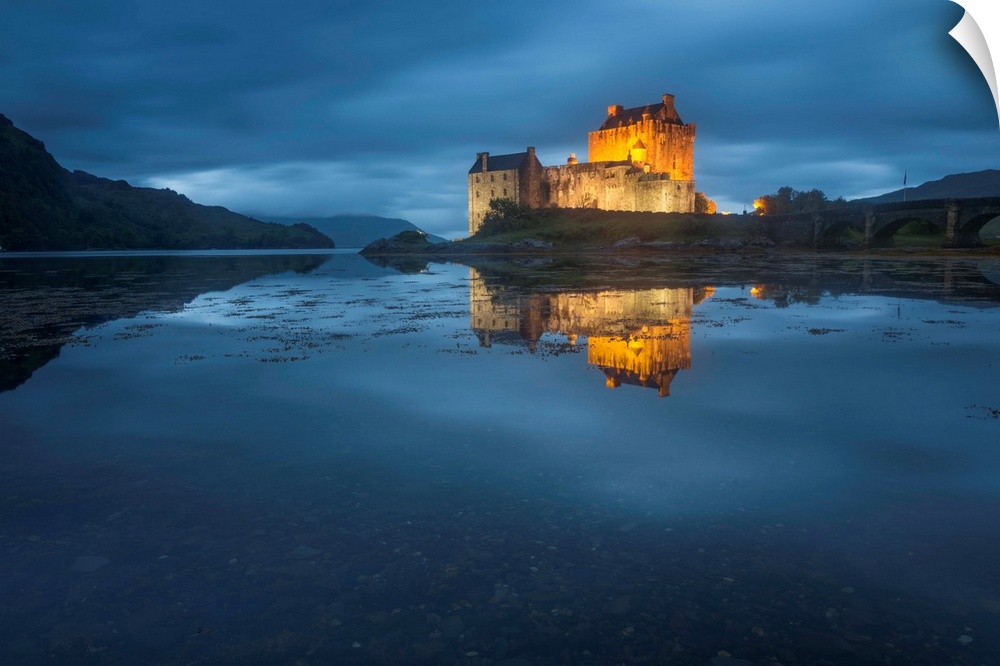 Photograph of old castle on Eilean Donan Island over Loch Duich, with mountains in the distant background,  Dornie Highlan...