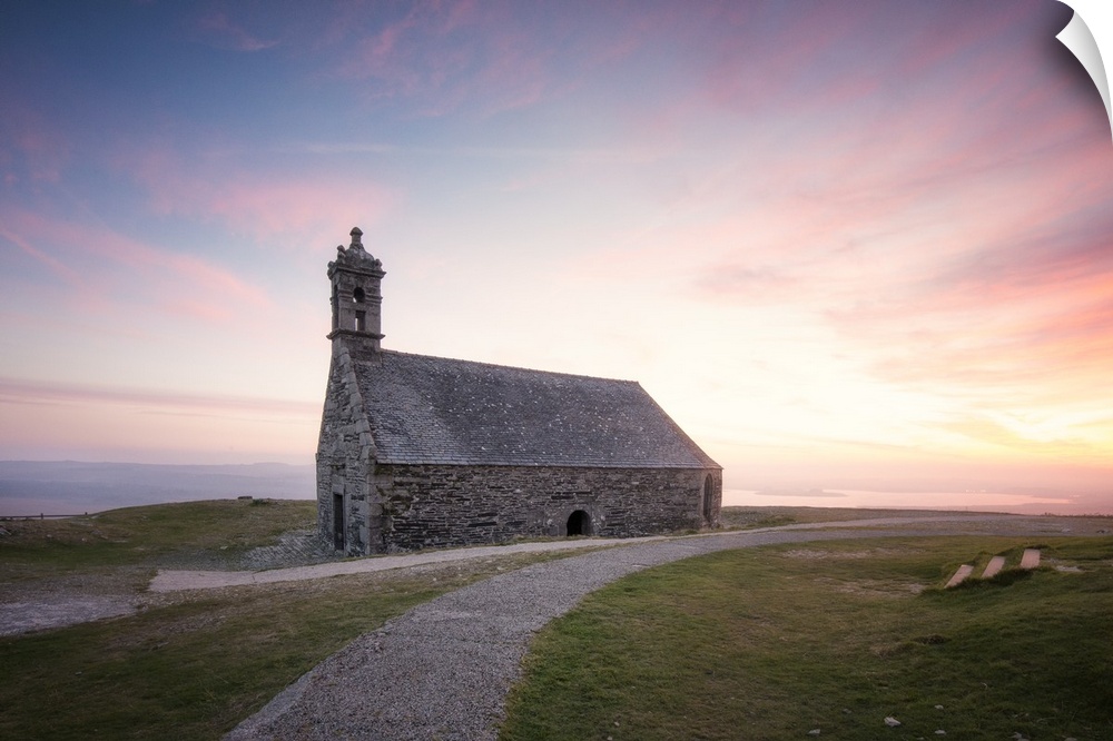 Photograph of a gravel path leading to Chapelle Saint Michel De Brasparts in France at sunset.