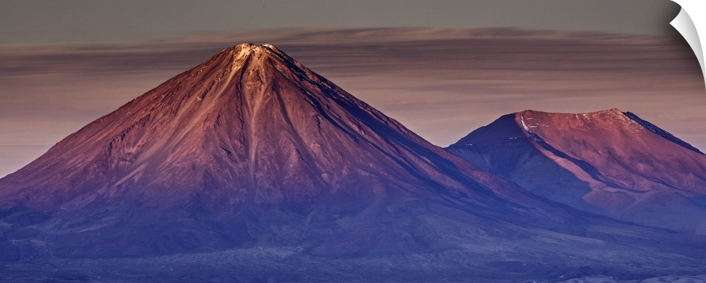 Reddish alpenglow on the peaks of the Andes mountains in Chile.