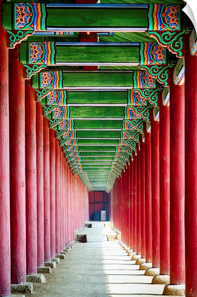 Looking down through the bright red columns of a royal building in South Korea.