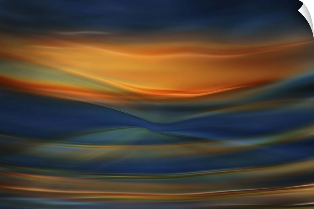 Abstract photograph of blurred and blended colors and flowing lines in shades of orange and blue.