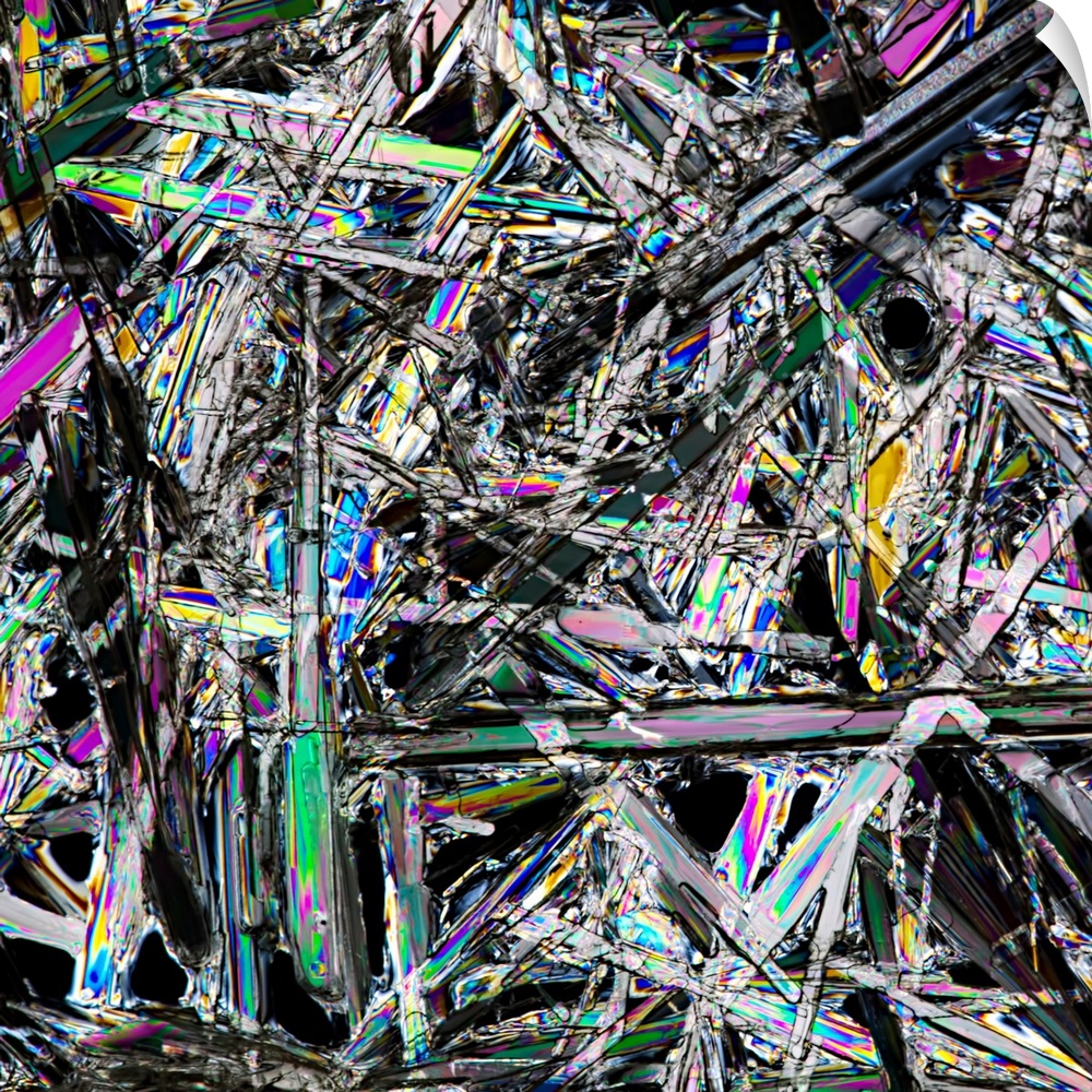 Close-up photograph of a white crystals with spectrum's of color in the facets.