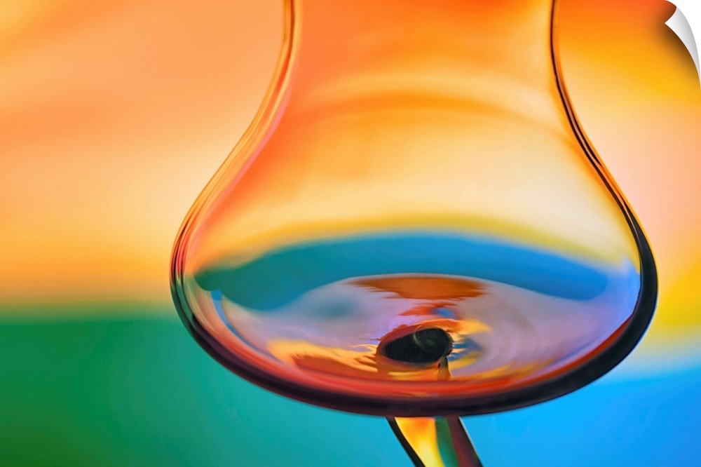 Abstract photo of a wine glass reflecting warped colors.