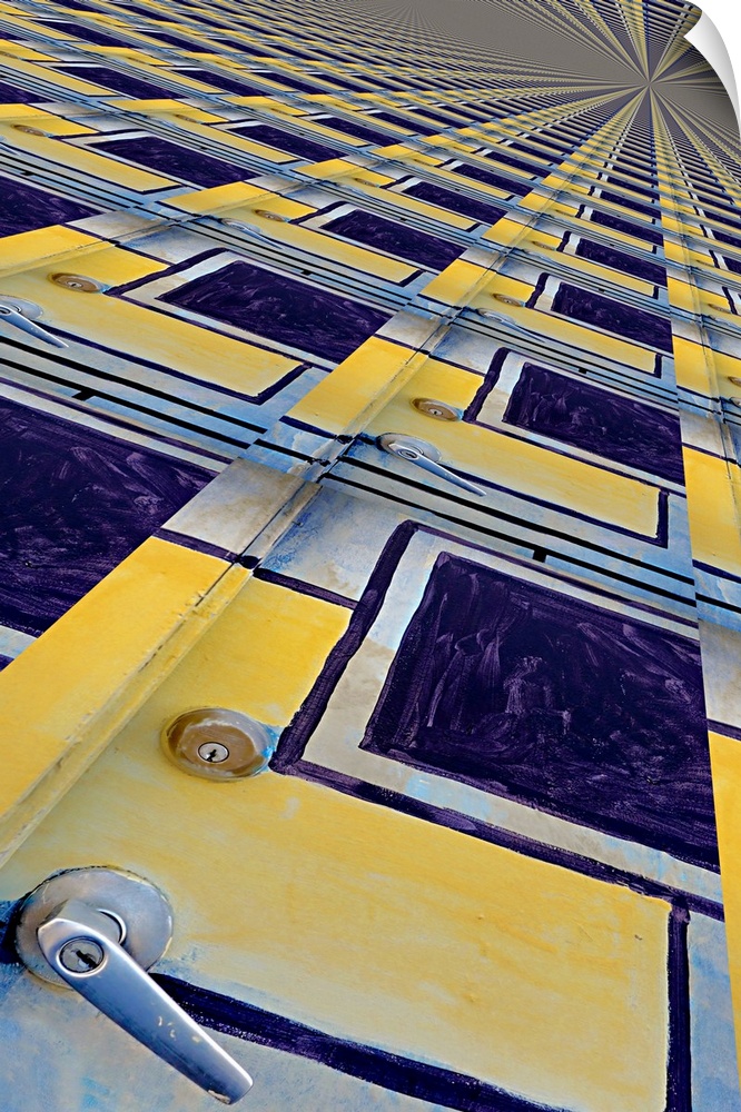 Image of a yellow and blue painted door repeated several times into a pattern, creating an abstract image.