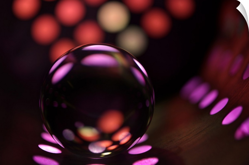 Abstract photo of a glass ball reflecting colored dots.