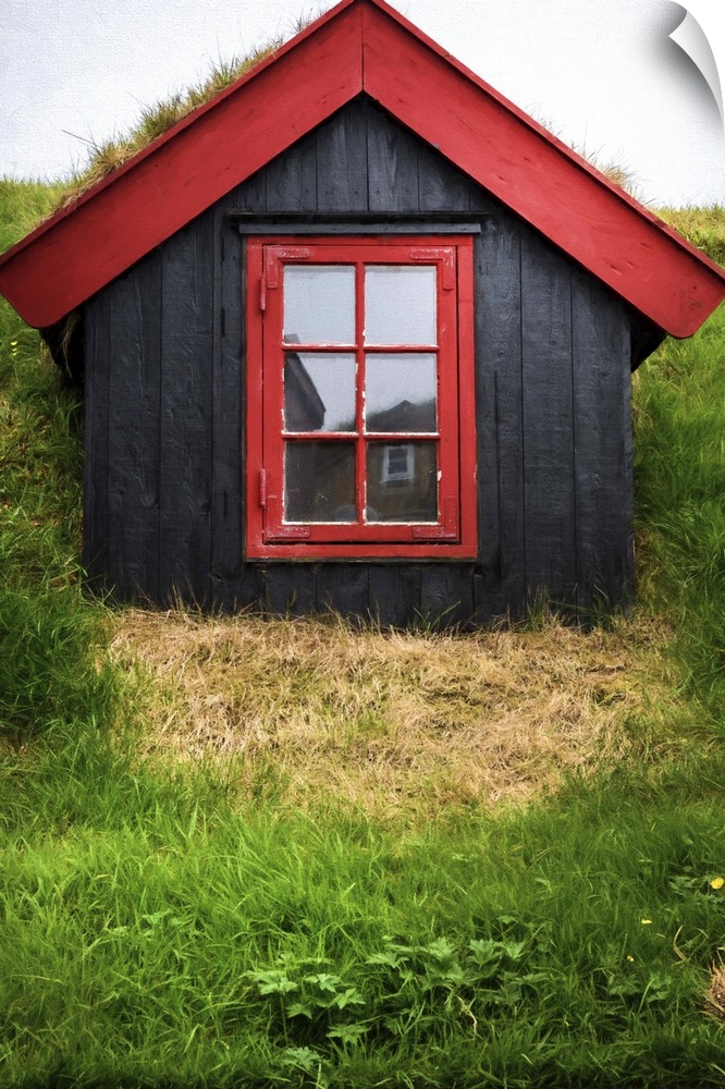 A small wooden house with black walls and red trim.