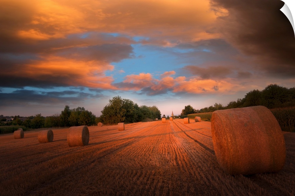 Sunset over bales of hay