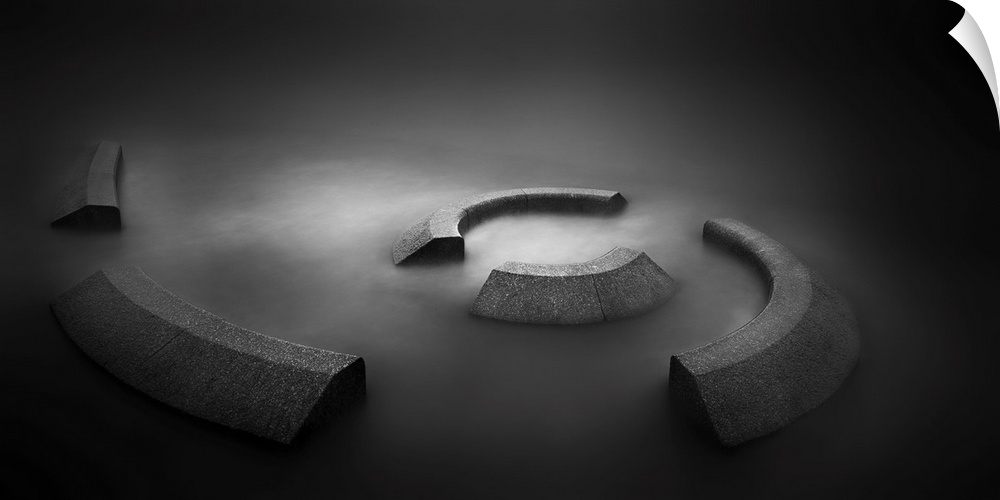 A contemporary dramatic monochrome black and white intense image of a spiral concrete installation with glowing still wate...