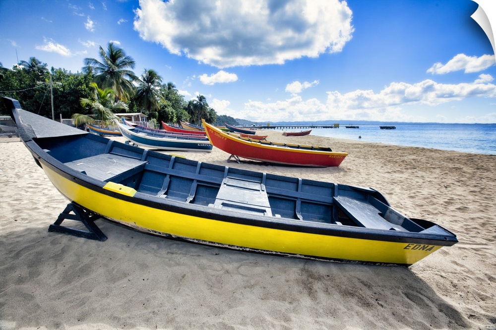 Low angle view of colorful, small wooden, fishing boats on a Caribbean beach, Crash Boat Beach, Aguadilla, Puerto Rico.