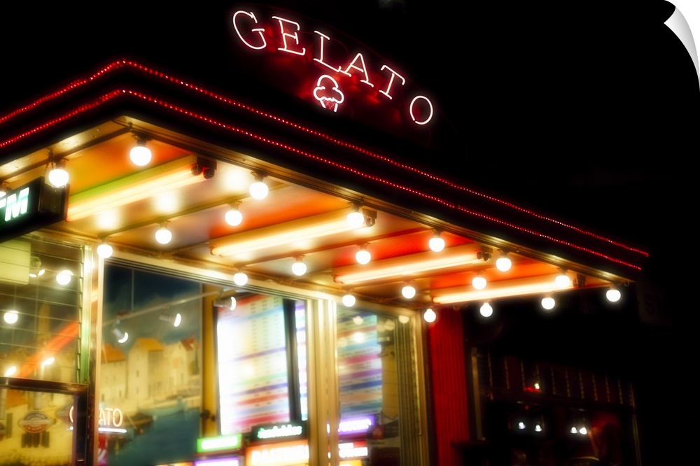 Neon signs of an ice cream parlour illuminating at night.