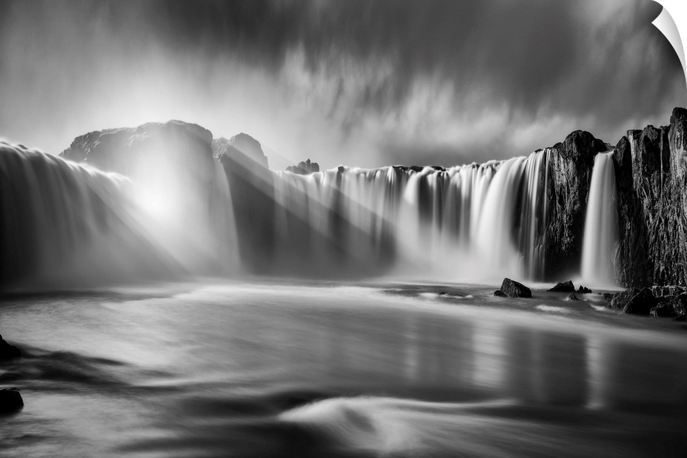 Fine art photograph of sunlight shining over the waterfalls in Iceland.