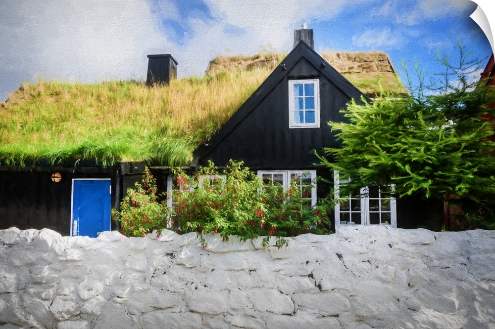 A black house with a blue door with a grassy roof.