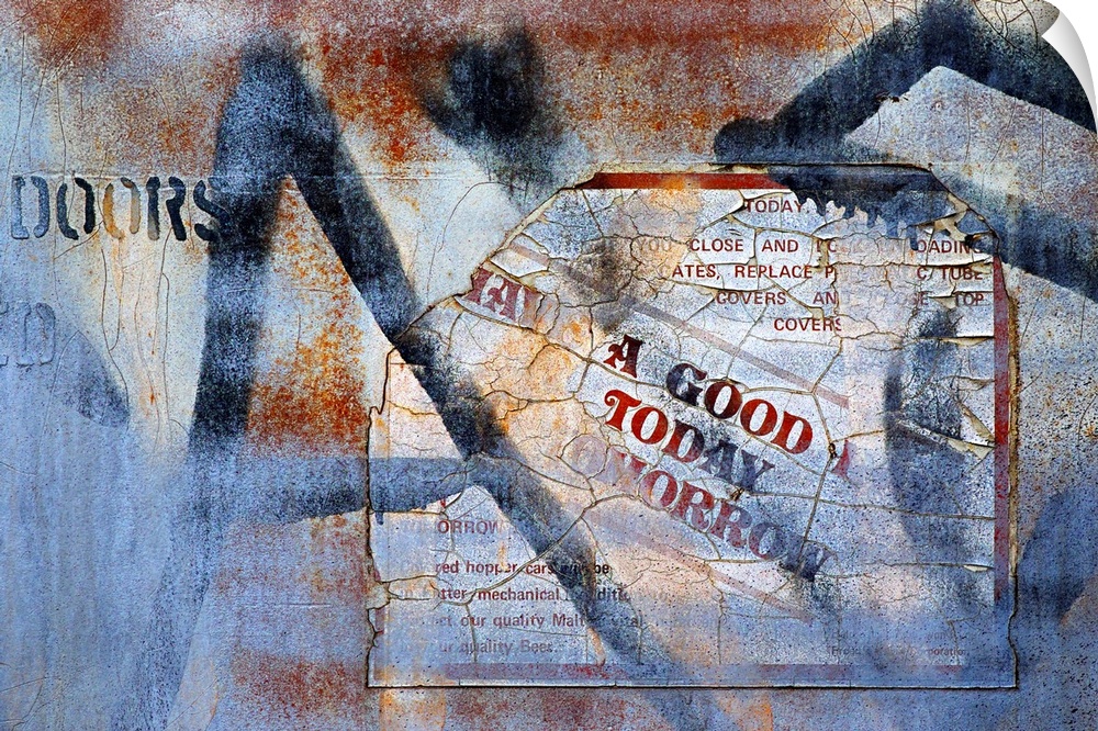A photo of a rusted metal door with a faded sign and graffiti.