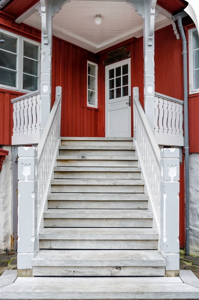 Staircase leading up to the entrance of a red house.