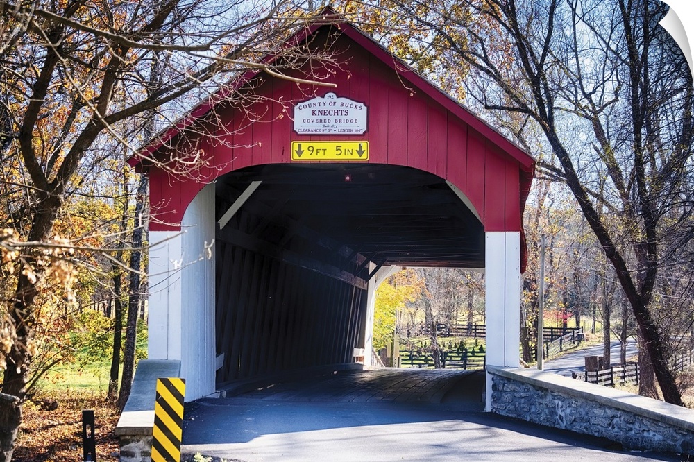View of the Knechts Covered Bridge over the crook creek, during fall. Bucks county, Pennsylvania, USA.