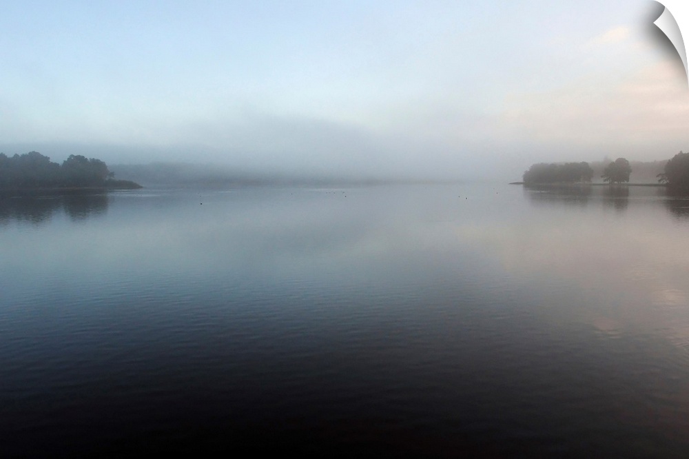 A quiet natural foggy lake in the middle of the forest of Broceliande in France, minimalistic work.