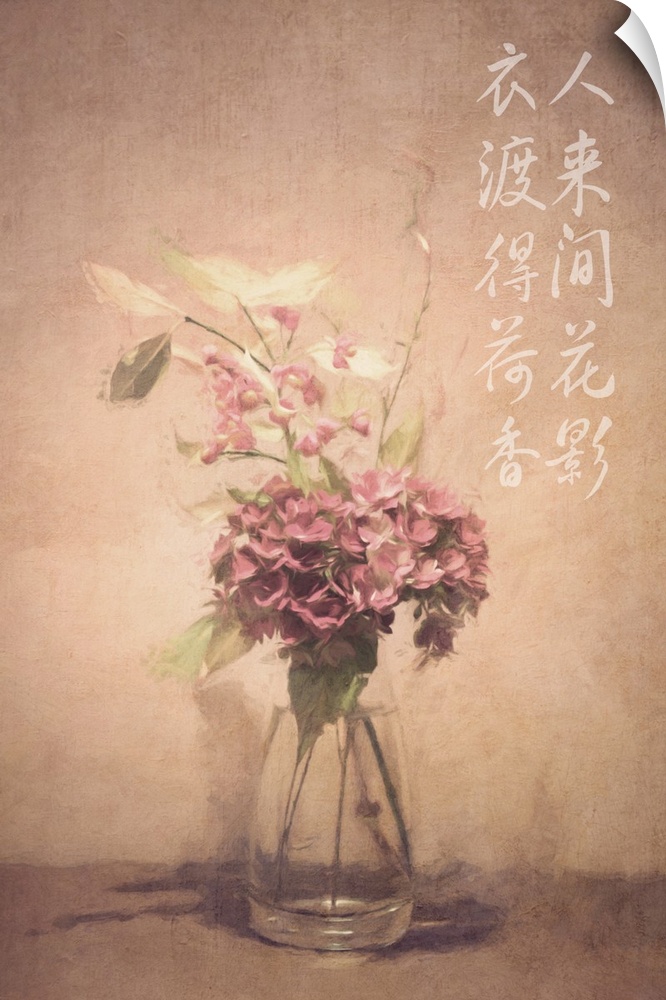 Asian calligraphy on a wall beside dusty pink and white flowers in a clear glass vase.