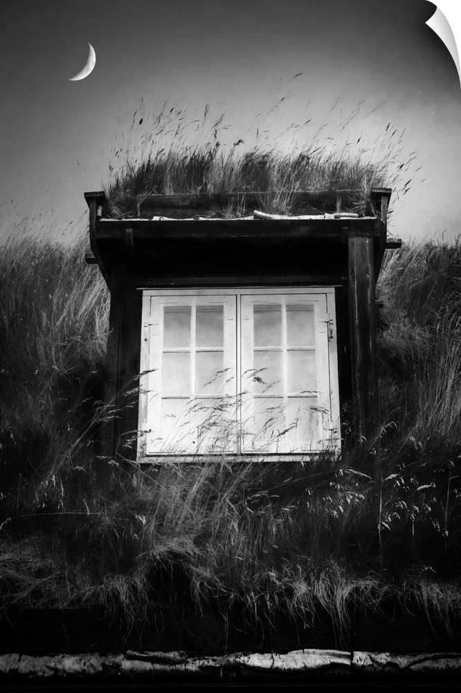 Black and white image of a small structure with white windows and a crescent moon above.