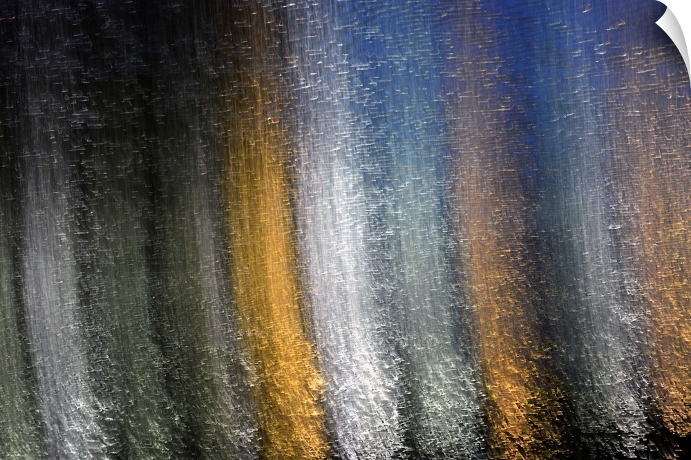 Fine art photograph of silver, gold, and white reflections of light on water in vertical lines.