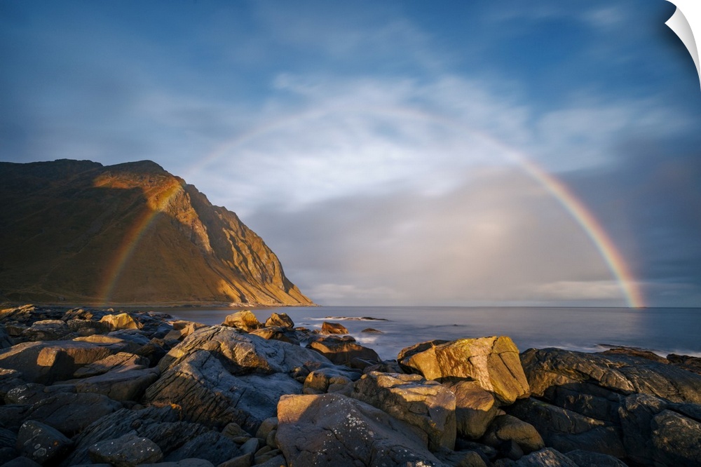 Sunrise at Napp, Lofoten, Norway. Just as I climbed onto the slippery rocks in the morning drizzle, the rainbow grew to it...