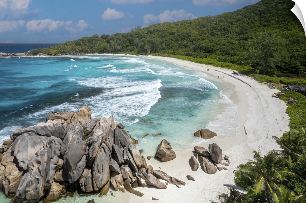 Dreamy white sandy beach with natural pools and crystal clear waters make Anse Cocos a spectacular marine cove on La Digue.