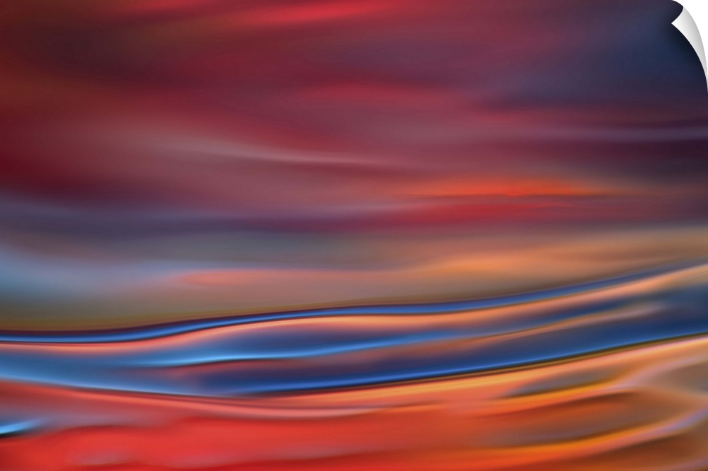 Abstract photograph in blue and red shades resembling ocean waves.