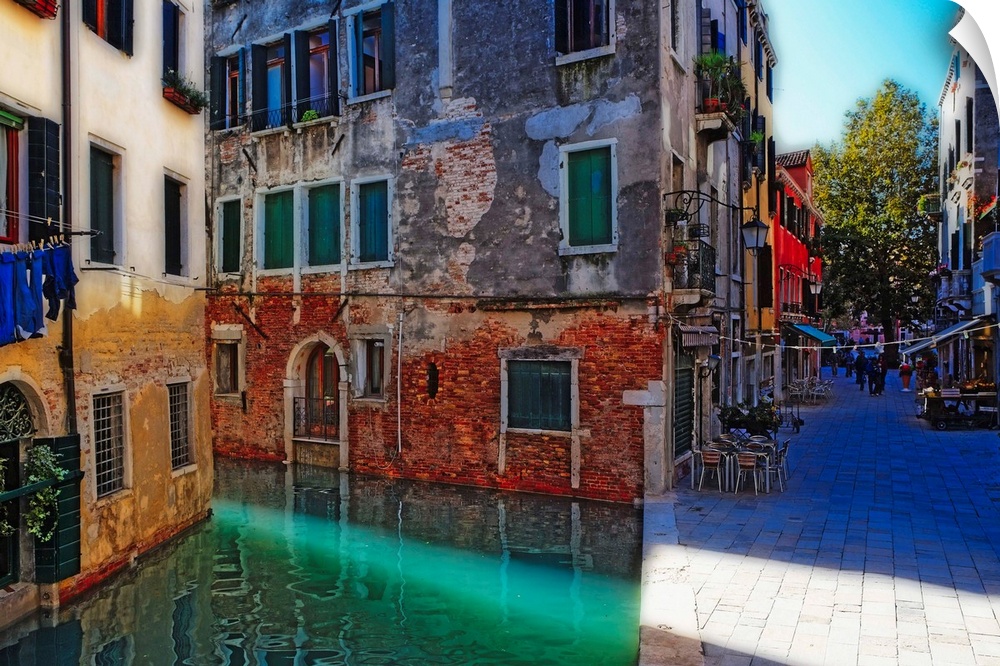 Giant, landscape photograph of tall buildings at the edge of a canal in Calle Del Spezier, Venice, Italy.  The canal leads...