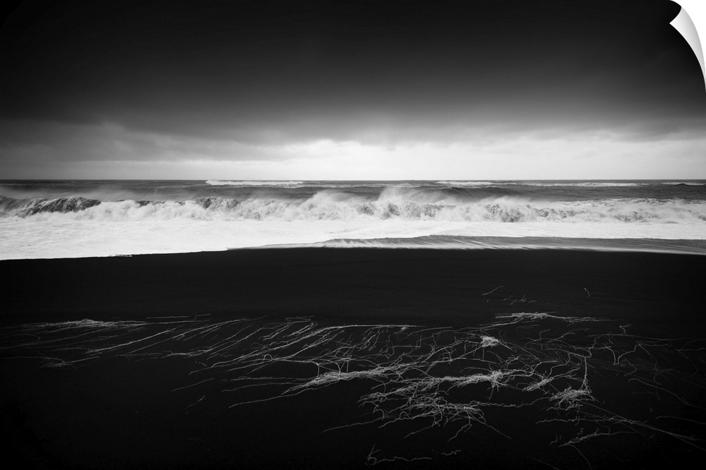 A photograph of a dark coastline under a dark sky.