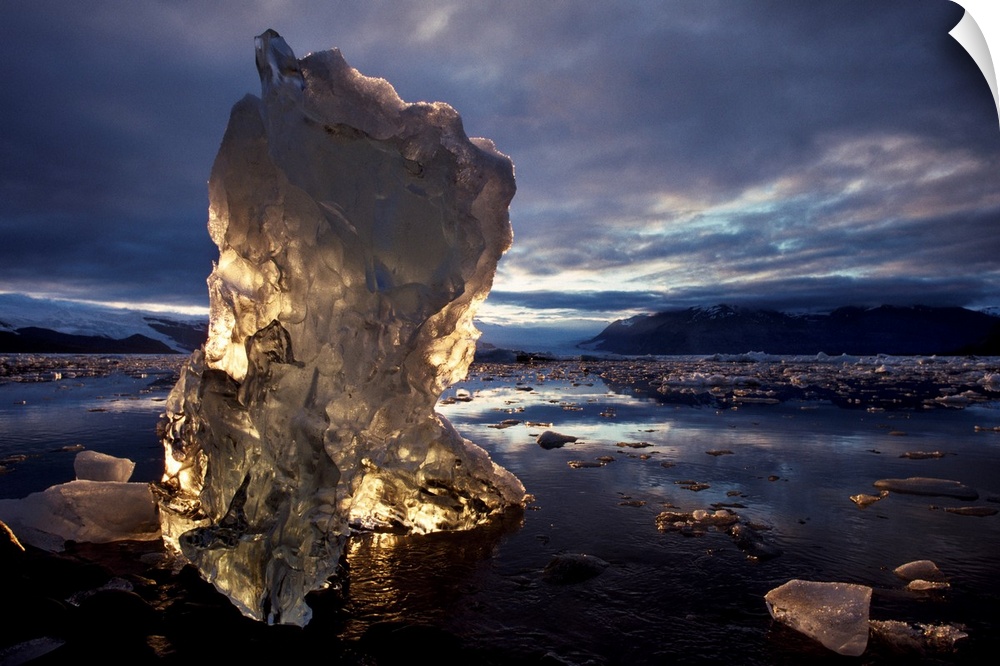 A chunk of an iceberg glows with sunlight coming through it, Alaska