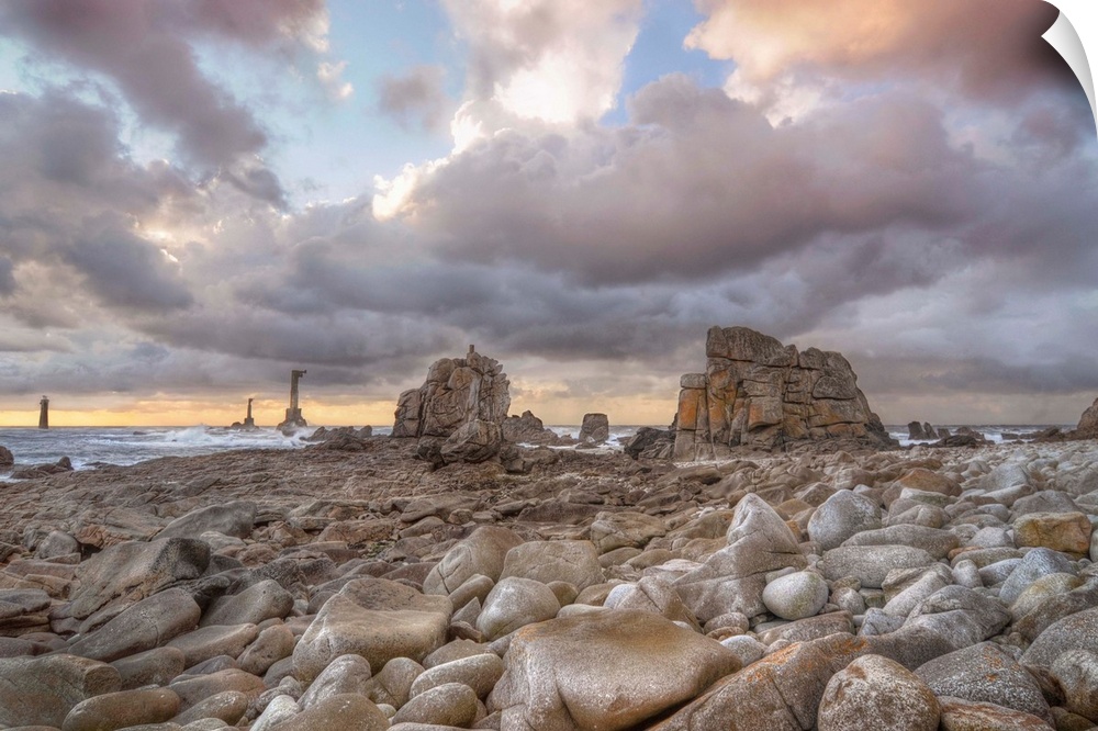 Colored sunset at Pointe de Pern place in Ouessant island in France among rocks.