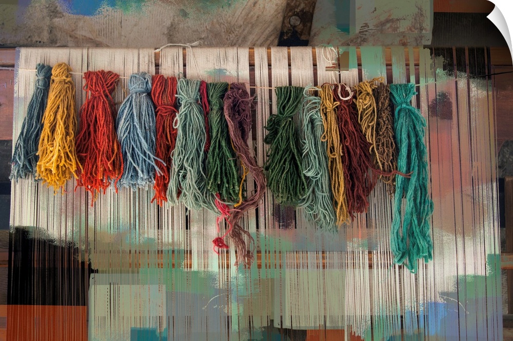 Photograph of colorful bundles of yarn hanging on a line with an abstract background.