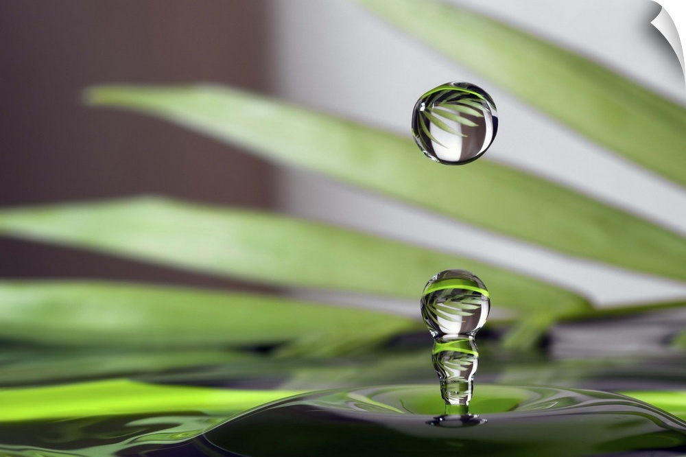A macro photograph of a water droplet sitting suspended in air against an abstract background.