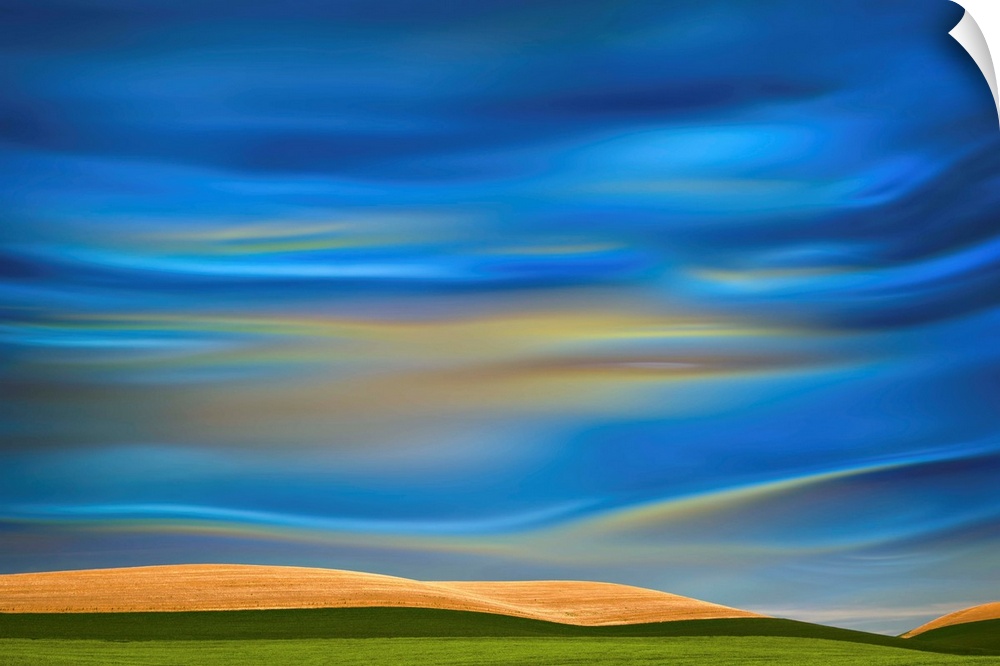 Abstract photograph of the Palouse farmland in Washington state, with a vibrant blue motion blurred sky.