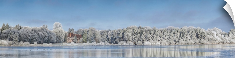 Panoramic photograph of a view across the lake from Broceliande Castle in winter.