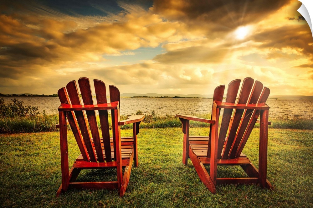 Two adirondacks in front of a sunset