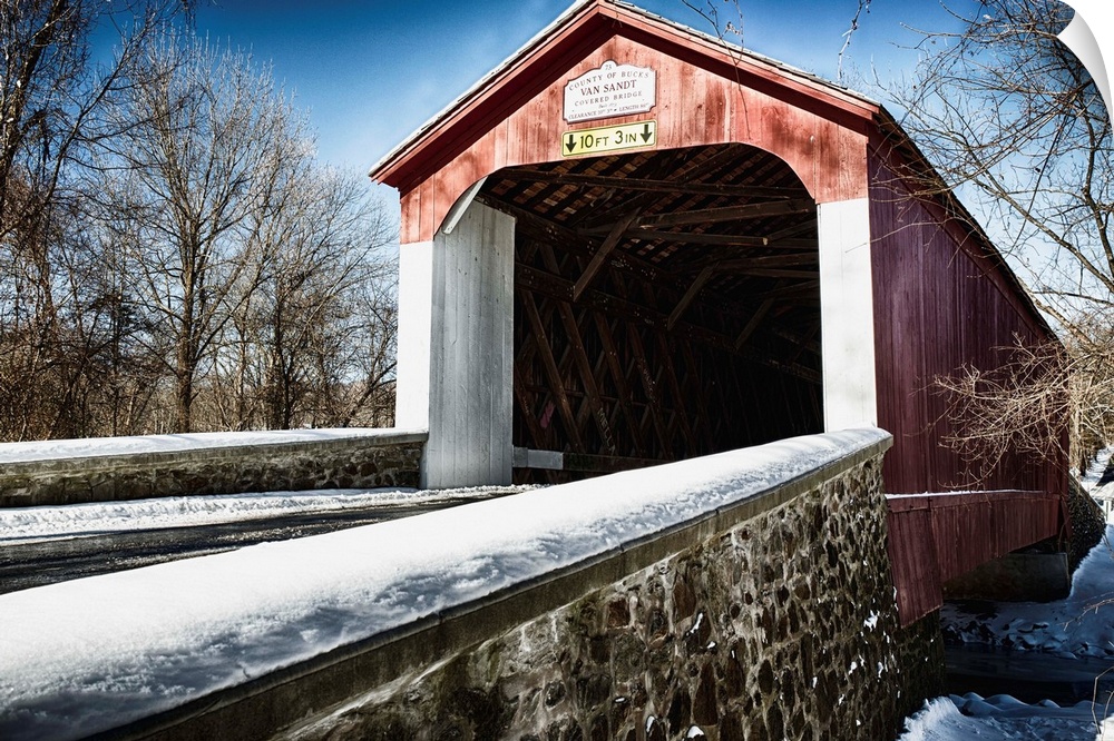 Fine art photo of a covered bridge under a light snowfall.