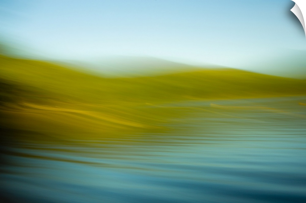 An abstract ocean scene of the water rhythmically flowing onto the gold beach.